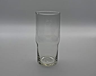 May include: A clear glass pint glass with a design etched on the side. The design includes a triangle and the number "0.20".
