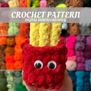 May include: Crochet pattern for a red and yellow french fry amigurumi toy. The toy has googly eyes and is holding a bunch of yellow french fries.
