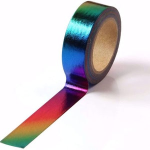 May include: A roll of iridescent rainbow washi tape. The tape is metallic and has a gradient of colors from green to blue to purple to red.