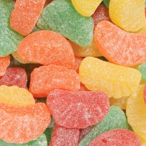 May include: Close-up of assorted colorful gummy candies. The candies are in the shape of orange slices and are coated in sugar. The colors include red, orange, yellow, and green.