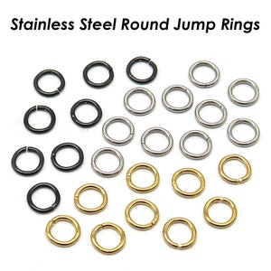 May include: A collection of round jump rings in black, silver, and gold. The rings are made of stainless steel and are perfect for jewelry making.
