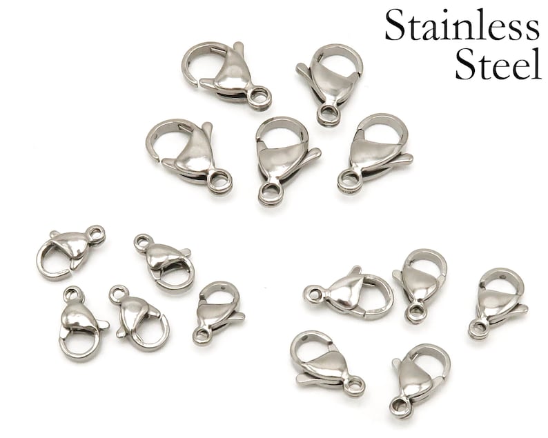 May include: A close-up of 14 silver-toned lobster clasps, made of stainless steel. These clasps are commonly used for jewelry making and crafting.