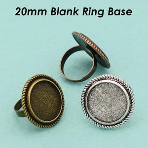 May include: Three 20mm blank ring bases. One is copper, one is silver, and one is brass.