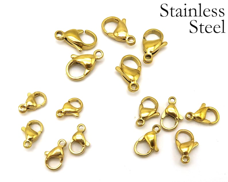 May include: A close-up of 14 gold-toned metal lobster clasps, made of stainless steel. These clasps are commonly used for jewelry making and crafting.