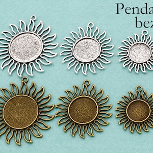 May include: Six silver and bronze sun-shaped pendant bezels with a circular opening in the center. The bezels are arranged in two rows of three. The top row is silver and the bottom row is bronze.