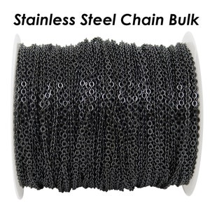 May include: A spool of black stainless steel chain. The chain is wound tightly around the spool, which is white.