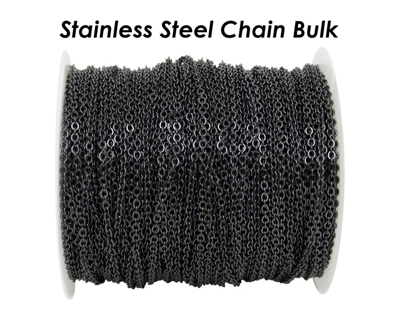 May include: A spool of black stainless steel chain. The chain is wound tightly around the spool, which is white.