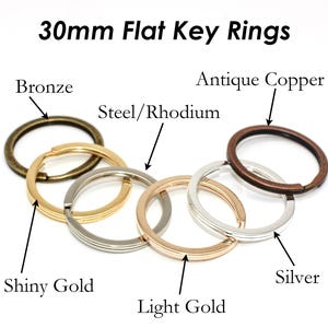 May include: A set of 30mm flat key rings in various finishes, including bronze, antique copper, steel/rhodium, shiny gold, light gold, and silver.