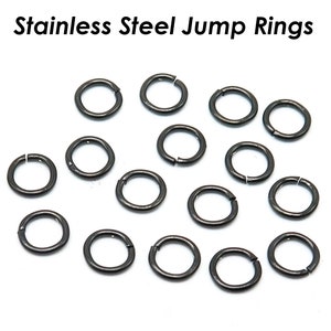 May include: A close-up of 17 silver jump rings, a type of jewelry finding used for connecting chains, cords, or other jewelry components.