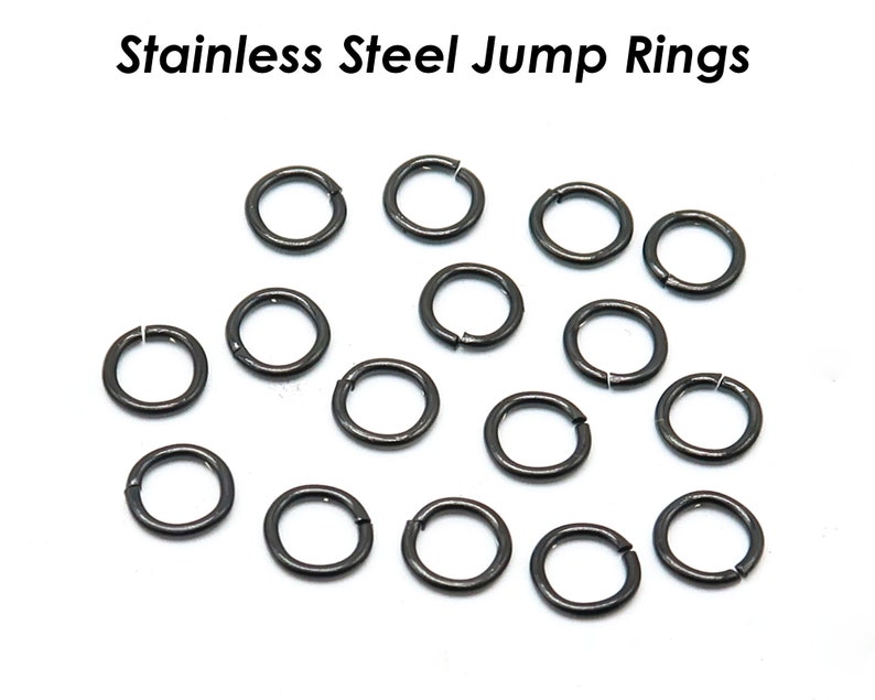 May include: A close-up of 17 silver jump rings, a type of jewelry finding used for connecting chains, cords, or other jewelry components.