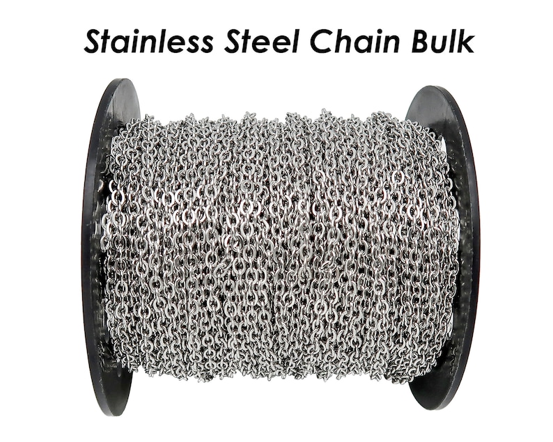 May include: A spool of silver stainless steel chain. The chain is wound tightly around the spool, which is black and has a smooth surface.