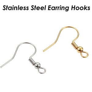 Puede incluir: Dos ganchos para pendientes de acero inoxidable. Un gancho es plateado y el otro es dorado.