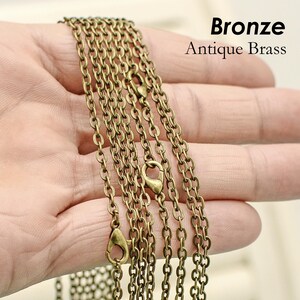 May include: Multiple strands of bronze antique brass chain with lobster claw clasps.