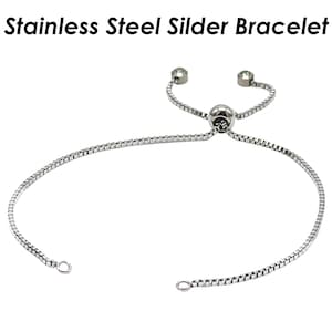 Puede incluir: Un brazalete deslizante de acero inoxidable plateado con una pequeña cuenta redonda en el centro. El brazalete es ajustable con dos pequeñas cuentas redondas en los extremos de la cadena.