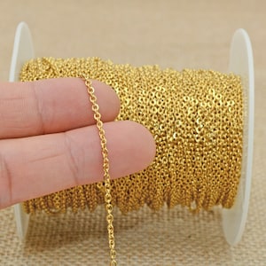May include: A spool of gold-colored chain, with a section of the chain held in a hand to show the size and detail.