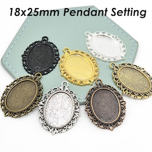 May include: An assortment of oval pendant settings in various metallic finishes, including black, gold, and antique bronze. The settings are approximately 0.7 x 1 inch and feature ornate filigree edges. Text on the image reads: 18x25mm Pendant Setting.