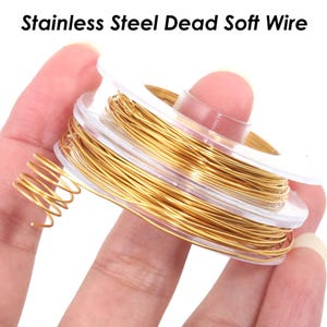May include: A spool of gold-colored stainless steel dead soft wire. The wire is wound around a clear plastic spool.