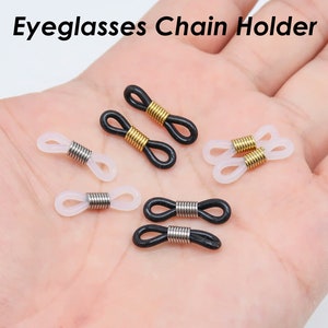 以下が含まれることがあります： 眼鏡チェーンホルダー6組。2組は黒で銀色の金属リング、2組は白で金色の金属リング、2組は白で銀色の金属リングです。