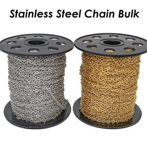 Puede incluir: Dos carretes de cadena de acero inoxidable, uno plateado y otro dorado, sobre un fondo blanco. Los carretes están etiquetados con "Stainless Steel Chain Bulk".