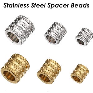 May include: A set of six stainless steel spacer beads. Three beads are silver and three beads are gold. The beads have a textured, diamond-like pattern.