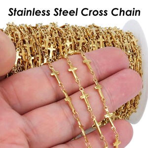 May include: A spool of gold-colored stainless steel cross chain. The chain is made of small, linked crosses.