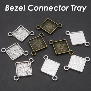 May include: An assortment of bezel connector trays in various shapes and finishes. The trays are square and diamond-shaped, with textured surfaces and small loops for connecting. The text "Bezel Connector Tray" is displayed at the top.