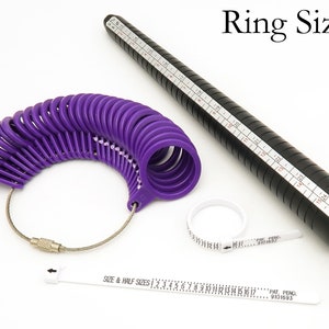 May include: A purple plastic ring sizer with a black metal ring sizer and a white plastic ring sizer with a measuring tape. The ring sizer has a chain attached to it. The ring sizer has the text "SIZE & HALF SIZES 1 2 3 4 5 6 7 8 9 10 11 12 13 14 15 16 17... PAT. PEND. 9101693" printed on it.