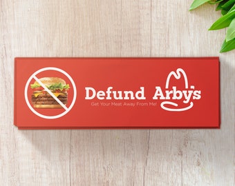 May include: A red sign with a white circle and a line through it, depicting a hamburger. The text "Defund Arby's" is written in white with the tagline "Get Your Meat Away From Me!" below. The Arby's logo is on the right side of the sign.