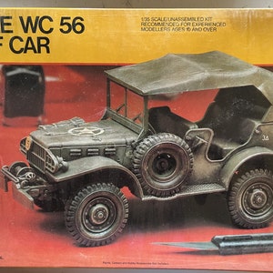 May include: A 1/35 scale unassembled model kit of a green Dodge WC 56 Staff Car. The kit is recommended for experienced modelers ages 10 and over. The box art features a detailed image of the vehicle with a canvas top and a star on the side.