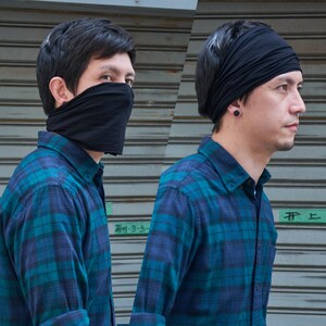 May include: Two people wearing blue and black plaid shirts. One person is wearing a black face mask and the other is wearing a black headband. The text "#F 上" is visible in the background.