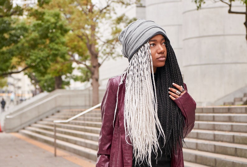 African American female model wearing grey layered slouchy beanie during summer