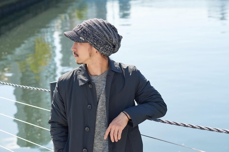Male Japanese model wearing a CHARM Acrylic slouchy beanie with visor on a sunny autumn day