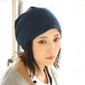 A Female Japanese model with brown hair wearing a navy summer beanie - a slouchy beanie for men and women