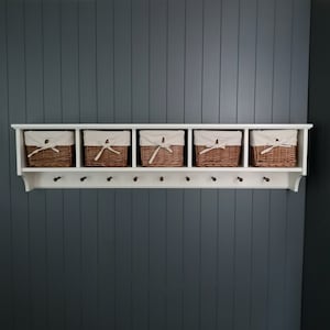 Painted wood coat rack with pegs, cubbies and baskets