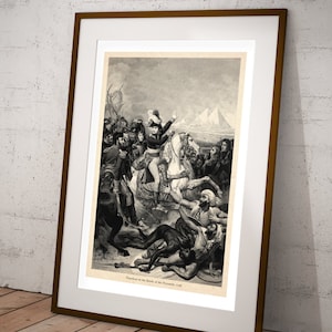 May include: A black and white engraving depicting Napoleon Bonaparte on horseback during the Battle of the Pyramids in 1798. The engraving shows Napoleon leading his troops against the Mamluks, with the Pyramids of Giza in the background. The text "Napoleon at the Battle of the Pyramids, 1798" is printed below the image.