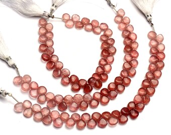 May include: Three strands of pink and red gemstone beads, each strand is approximately 18 inches long and features a tassel at each end.