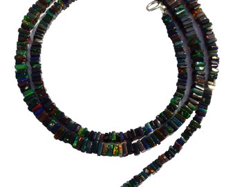 May include: A black opal necklace with a silver clasp. The necklace is made of square-shaped beads with iridescent colors.