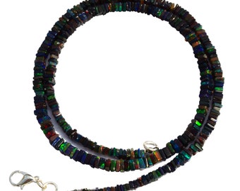 May include: A black opal necklace with a silver clasp. The necklace is made of square-shaped beads with iridescent colors.