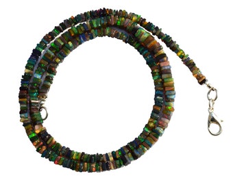 May include: A multi-strand necklace made of small, rectangular, iridescent opal beads. The necklace is made of a variety of colors, including green, blue, red, and brown. The necklace has a silver clasp.
