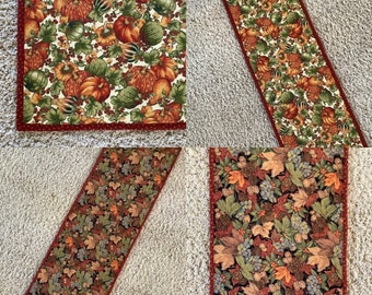 Quilted reversible table runner for fall autumn.  Pumpkins, leaves gourds and pine cones.  13” x 41”.   Free shipping.