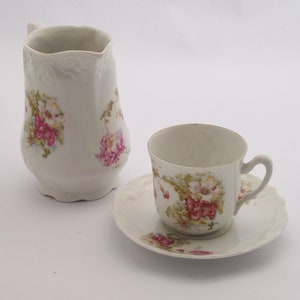 Tea set with a cup a saucer and a milk jug thin porcelain flowered with relief pattern  vintage