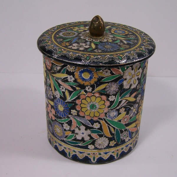 Round embossed tin box with lid brass button flowers and leaf on black  background vintage Made in Netherlands