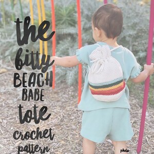 May include: A child wearing a light blue shirt and shorts carries a white crocheted tote bag with a colorful striped design. The text "the bitty beach babe tote crochet pattern" is written in black on a brown background.