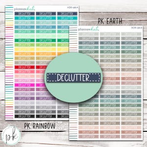 May include: Two sheets of rectangular planner stickers labeled PK RAINBOW and PK EARTH, featuring the word DECLUTTER in white text with a dashed border. The stickers come in a variety of colors, including blues, greens, yellows, reds, and neutrals.