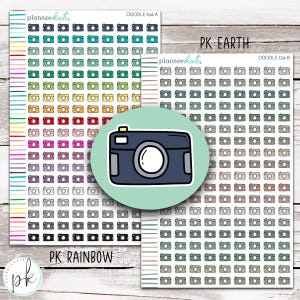 May include: Sheets of planner stickers featuring camera illustrations in various colors, including teal, green, yellow, red, pink, and gray. A circular sticker with a blue camera design is also present. The text "PK RAINBOW" and "PK EARTH" are visible.