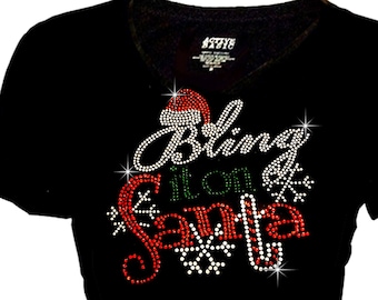 May include: Black v-neck t-shirt with a rhinestone design that says "Bling It On Santa" with a Santa hat and snowflakes.