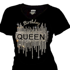 May include: Black v-neck t-shirt with a rhinestone design that says "Birthday Queen".