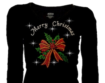 May include: Black long-sleeved shirt featuring a sparkly red bow and green holly leaves, with the text "Merry Christmas" in silver glitter.