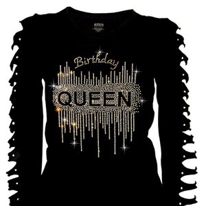 May include: Black long-sleeve shirt with a rhinestone design that says "Birthday Queen". The sleeves have intentional rips.