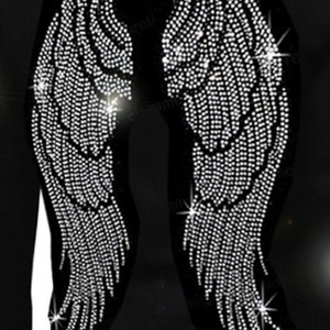 May include: A black garment with a pair of large angel wings made of rhinestones. The wings are detailed with rows of sparkling crystals.